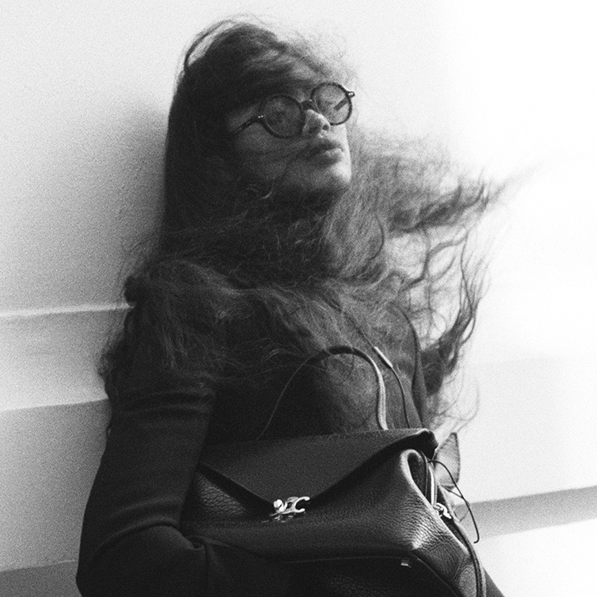 a woman wears the celine flair bag.
