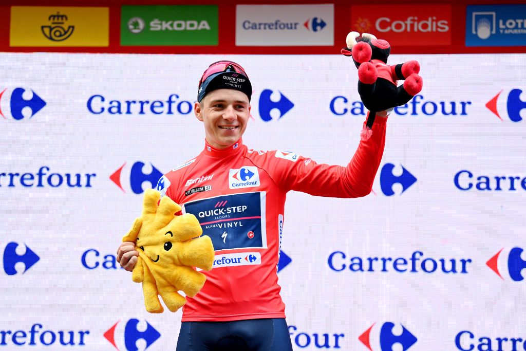 ALICANTE SPAIN AUGUST 30 Remco Evenepoel of Belgium and Team QuickStep Alpha Vinyl celebrates winning the Red Leader Jersey on the podium ceremony after the 77th Tour of Spain 2022 Stage 10 a 309km individual time trial stage from Elche to Alicante LaVuelta22 WorldTour on August 30 2022 in Alicante Spain Photo by Justin SetterfieldGetty Images