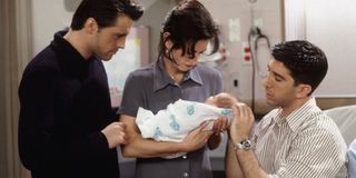 Monica holding Ben next to Joey and Ross in Friends.