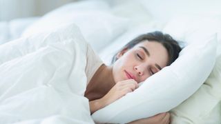 How many pillows should you use - woman sleeping in bed