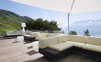 Outside decking with seating and view of water and hills