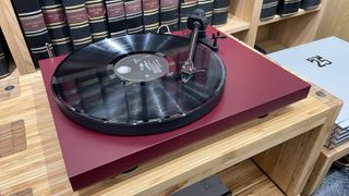 Pro-Ject Debut Evo 2 turntable slight top-down angle with vinyl record playing