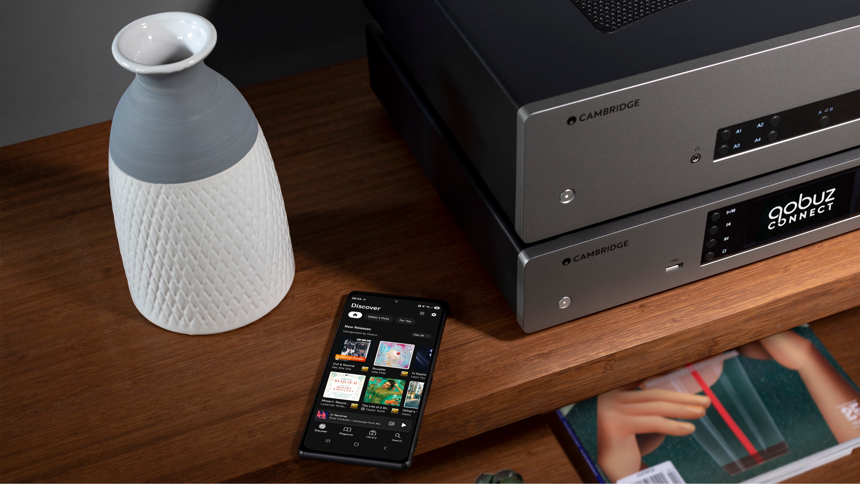 Cambridge Audio music streamers with Quboz Connect on the display and a smartphone