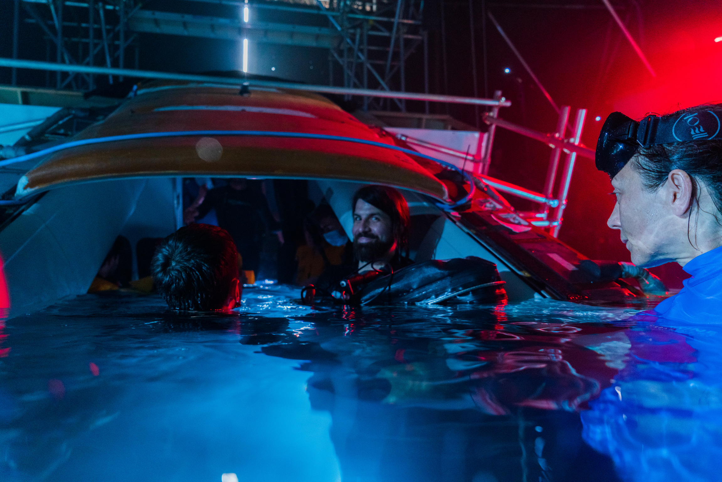 A group of people filming inside a submerged airplane