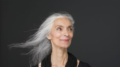 Woman with long grey hair smiling