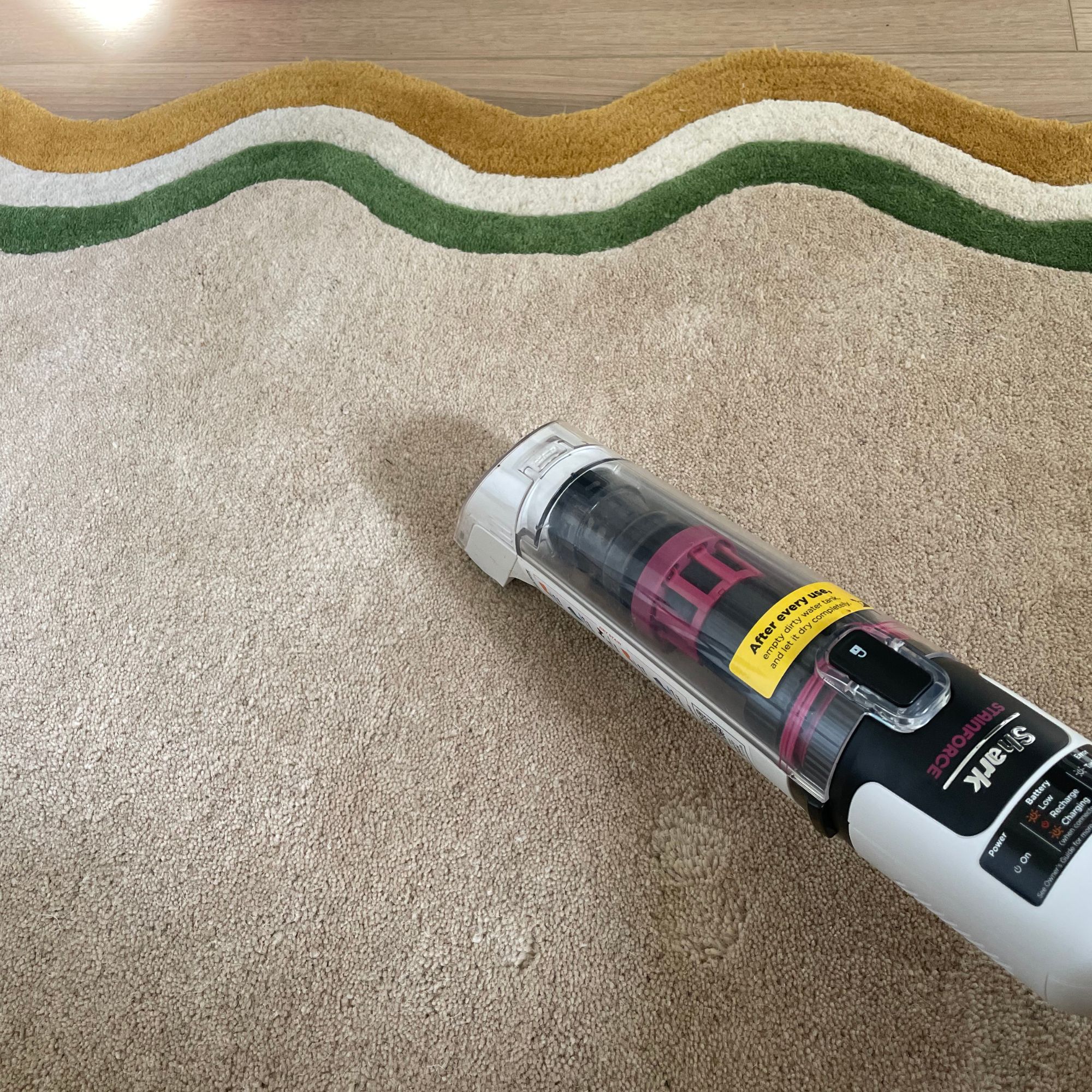 Using the Shark Stainforce Spot Cleaner on a cream rug