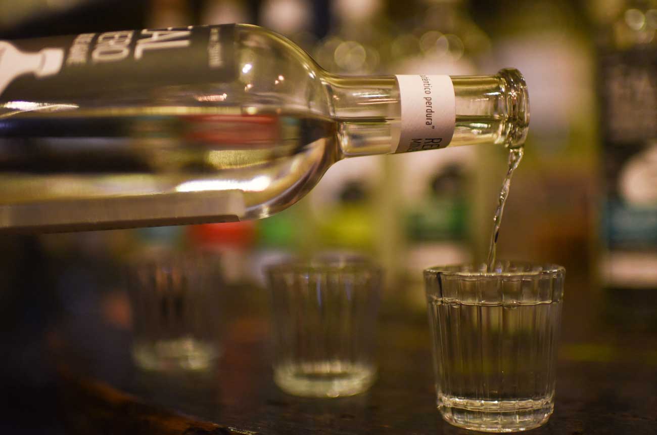 Mezcal being poured from a bottle