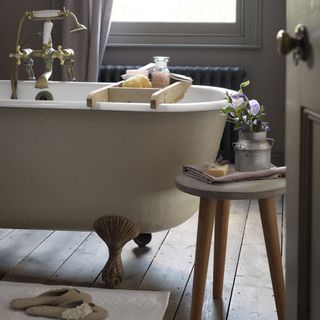bathroom with bathtub and wooden floor and sidetable