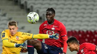 ille's Mozambican defender Reinildo Mandava heads the ball ahead of the Egypt vs Mozambique live stream