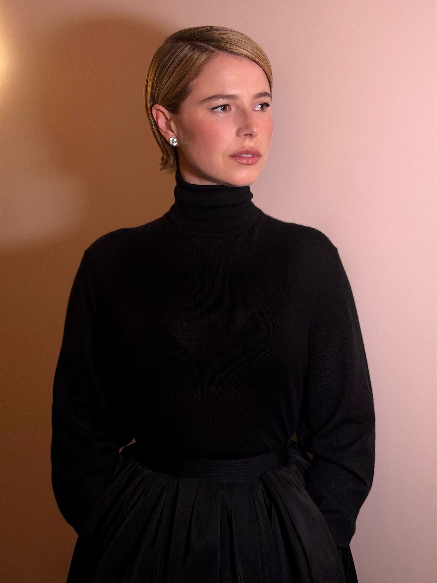 Jessie Buckley getting ready for the Governors Awards with short, slicked-back caramel bronde hair