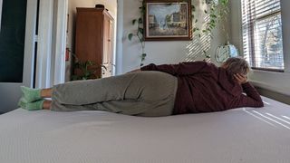 Member of testing panel lying on her side on PurpleFlex mattress