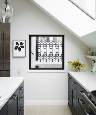 black and white kitchen with window and baseboards