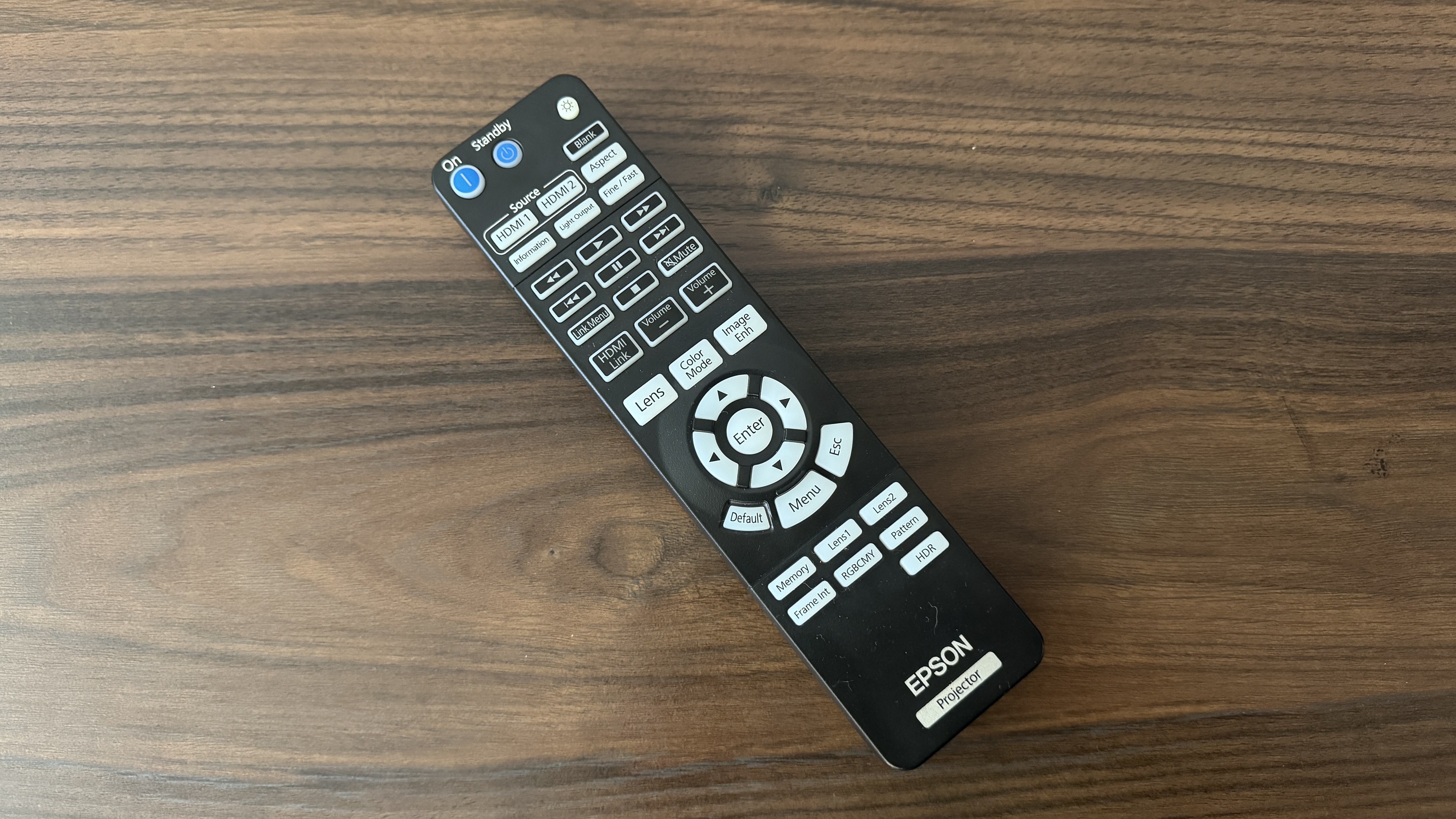 Epson Pro Cinema LS9000 remote control on wood surface