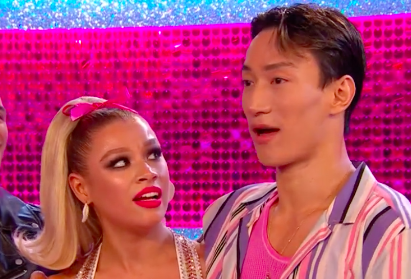 Molly and Carlos wait for their scores for their jive