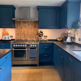 navy blue kitchen with island and oven