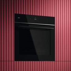 AEG steam oven built into red cabinetry