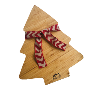 Wooden Christmas tree shaped cutting board with a bow