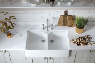 white double belfast sink in utility room with grey worktop surround