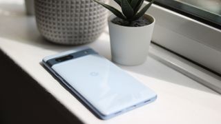 Google Pixel 7a phone rear on a white windowsill