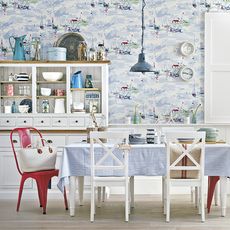 Dinning table with chair white cabinet wallpaper on wall and wooden flooring
