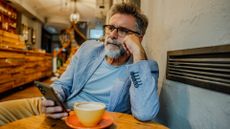 Man on phone in cafe