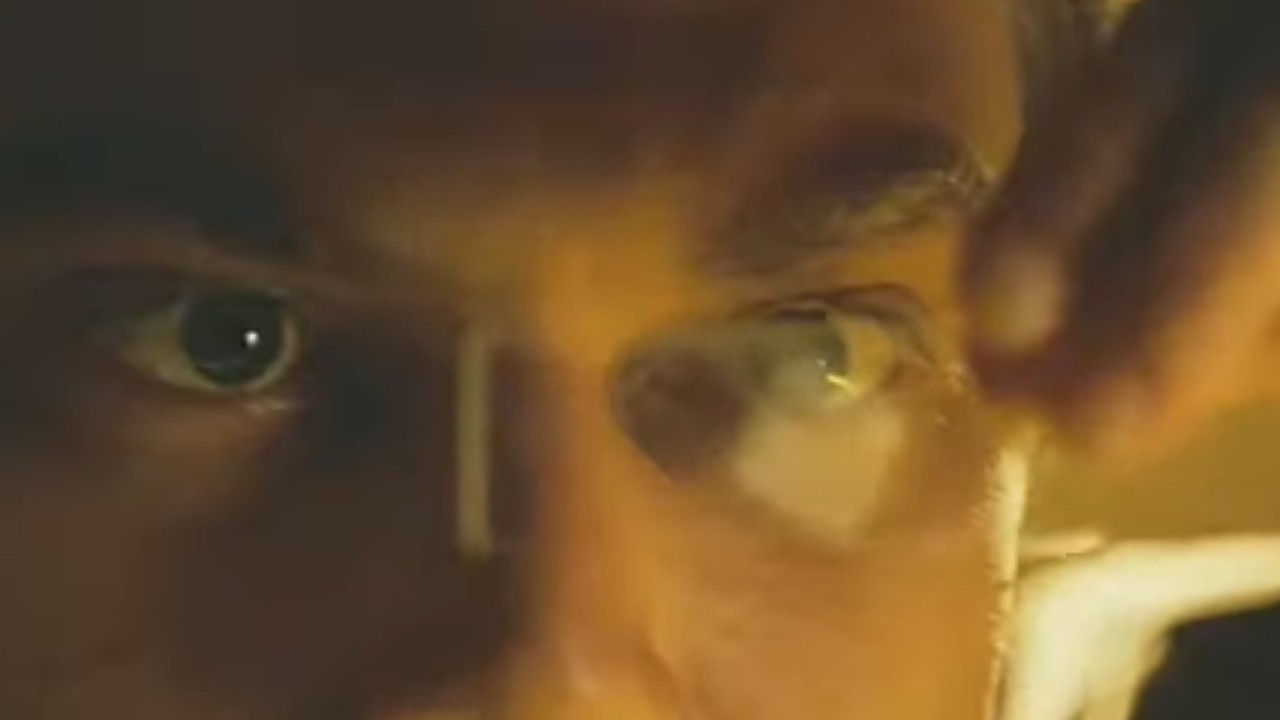 Michael Shannon staring at something tiny in Bug