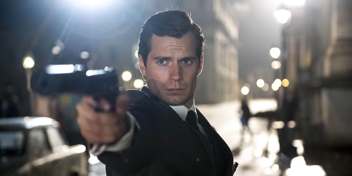 Napoleon Solo (Henry Cavill) points a gun while wearing a suit in &#039;The Man from U.N.C.L.E.&#039;