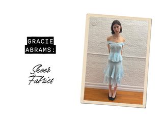 @gracieabrams wearing sheer blue top blue skirt, and black heels.