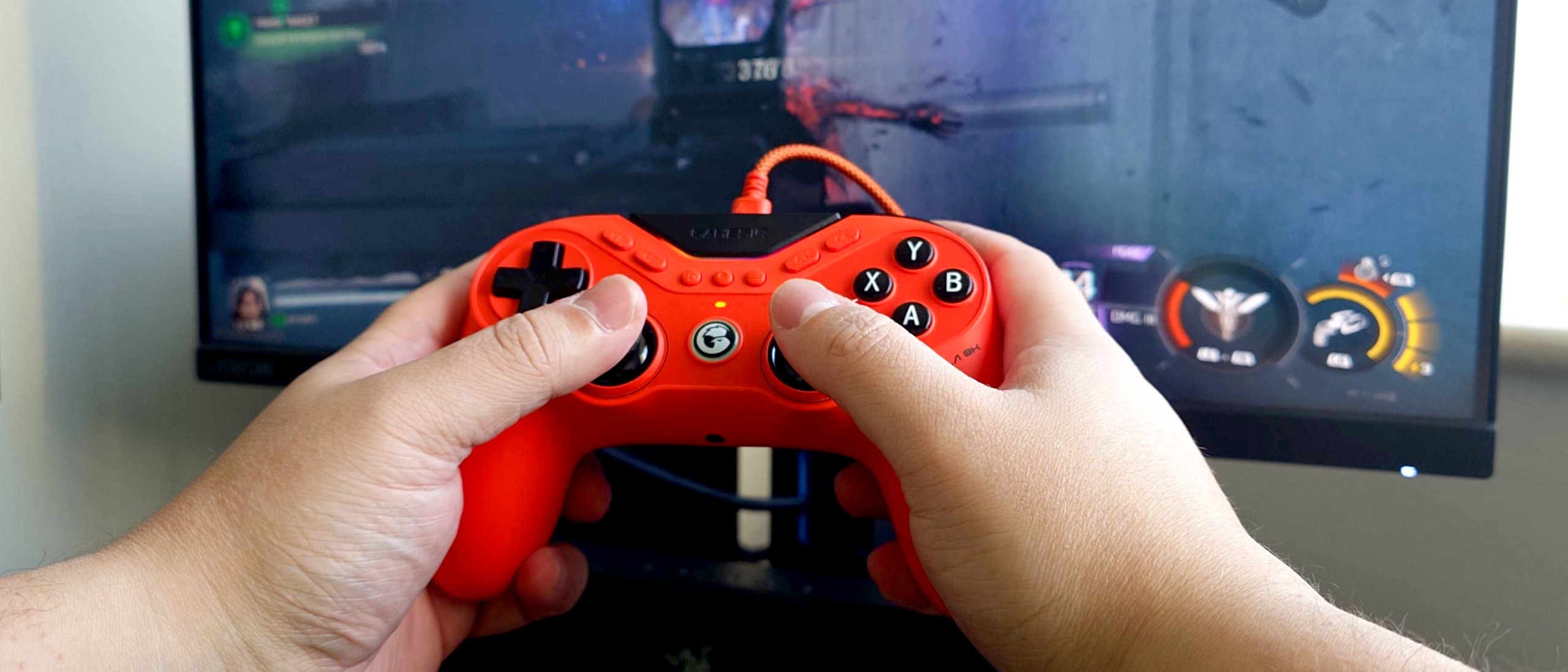 A photo of the orange GameSir Tarantula 8K controller playing Call of Duty: Black Ops 7