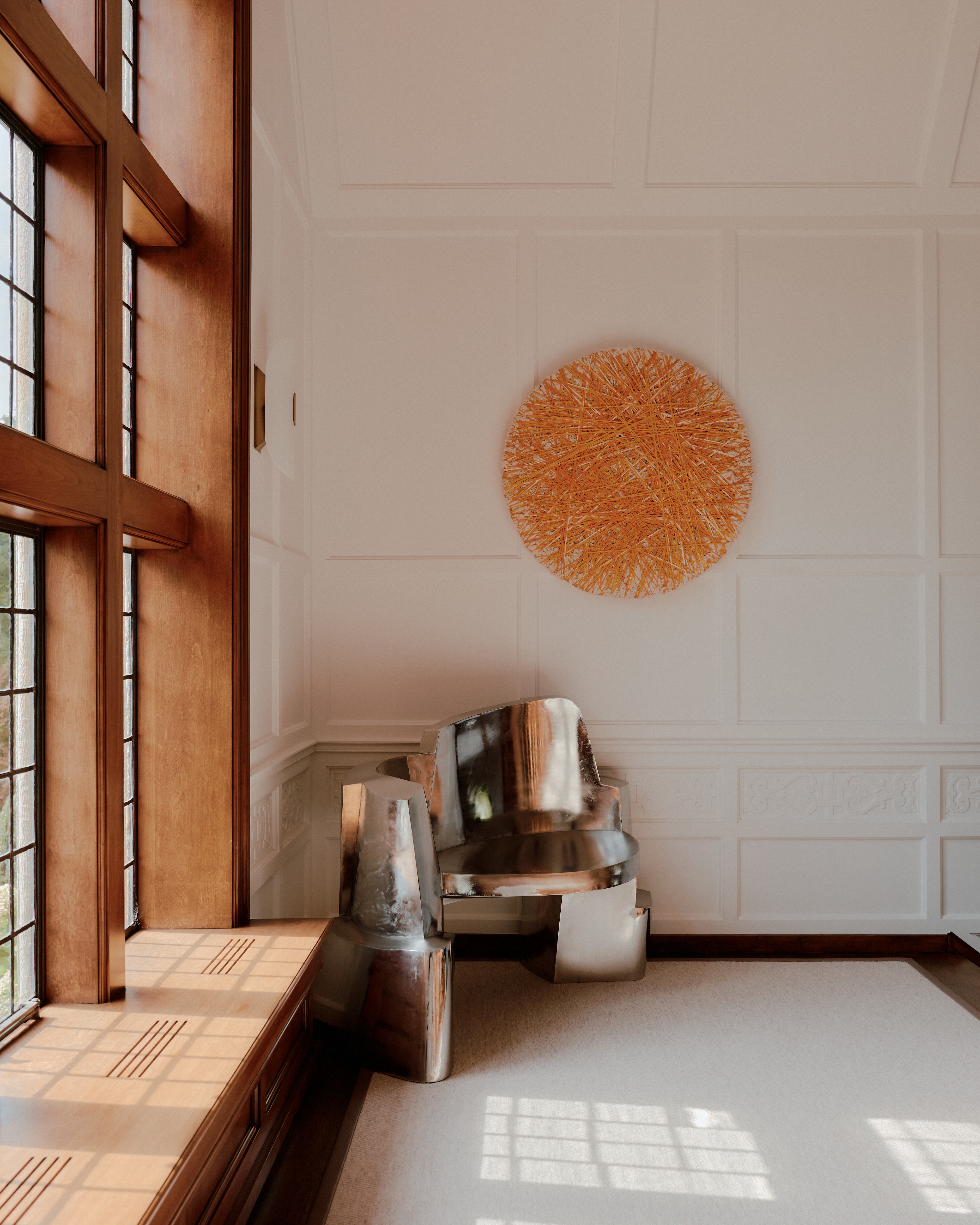 Sun-lit interior of a palatial residence wooden windows, white-washed walls, and artful decor.