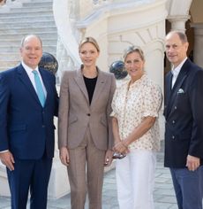 Prince Albert, Princess Charlene, Duchess Sophie and Prince Edward posing in front of the palace in Monaco