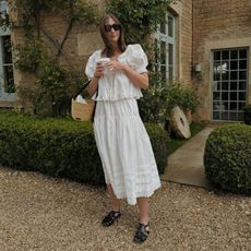 Provincial girl style Rachael Keegan in white top and skirt with basket bag and fisherman sandals