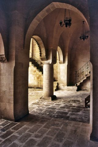 Krak des Chevaliers is a Crusader castle in Syria. This image combines highlights from incoming sunlight, corrected verticals and deep shadows