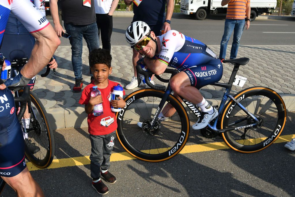 Mark Cavendish with a young fan after stage 1 of the Tour of Oman