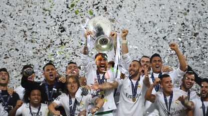 Real Madrid's Sergio Ramos lifts the Champions League trophy after his team's victory against Atletico Madrid in Milan