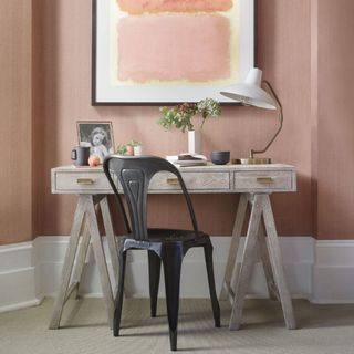 room with peach and white wall and study table