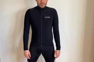 Image shows a person wearing the Le Col Pro Aqua Zero long sleeve jersey.