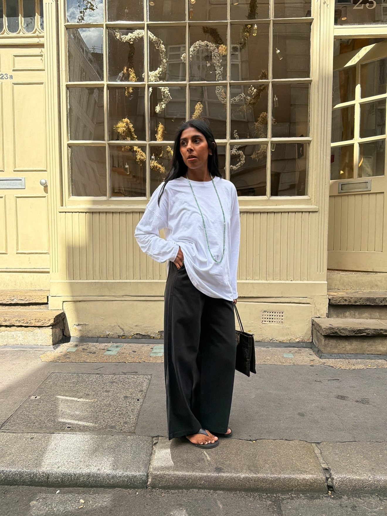 Woman in white long sleeve tee and black jeans
