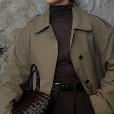 @brittanybathgate in a brown turtleneck and trench coat