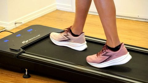 a photo of feet walking on the goplus walking treadmill