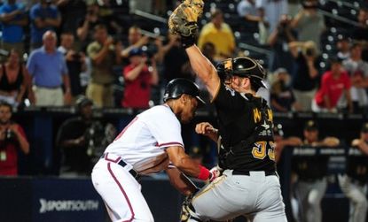 Julio Lugo (left) of the Atlanta Braves scores the controversial game-winning run in the 19th inning against the Pittsburgh Pirates Tuesday night. 