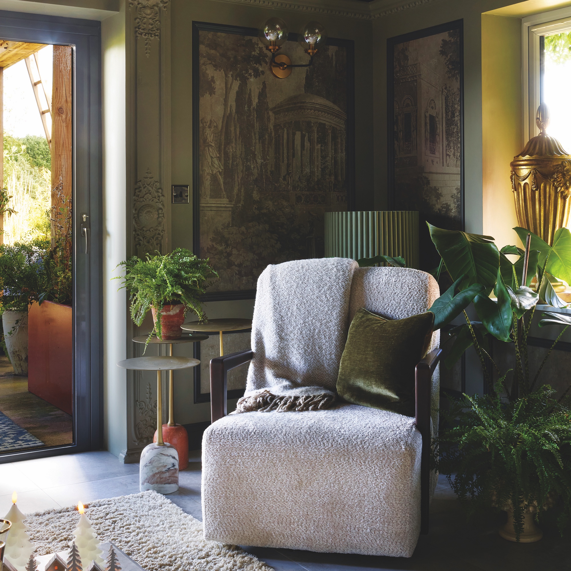 snug with white boucle armchair and murals on wall