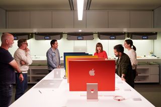 View of Apple Industrial Design Team members at Apple Park discussing colour, alongside the new iMac