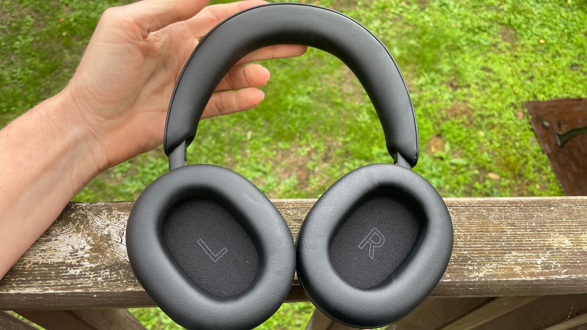 Technics EAH-A1000 headphones in black, in a garden