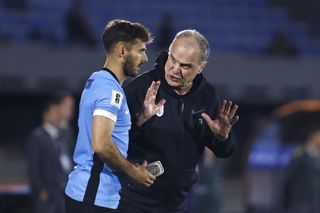 Uruguay coach Marcelo Bielsa gives instructions to Marcelo Saracchi in a game against Ecuador in October 2024.