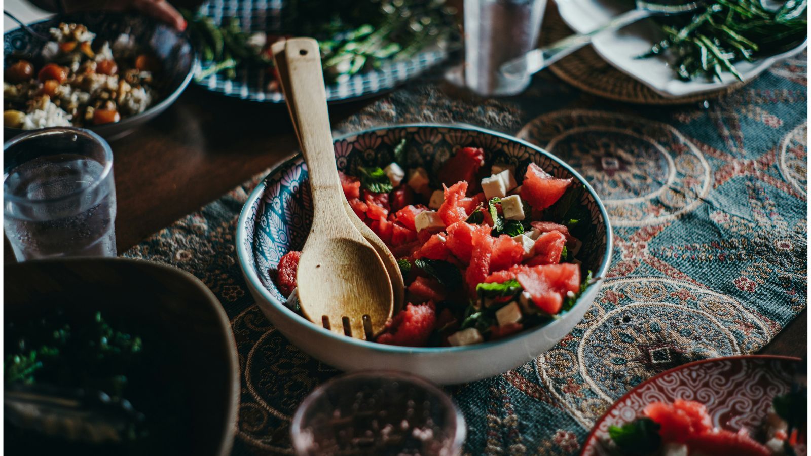 Teal patterned tablecloth with bowl of watermelon salad