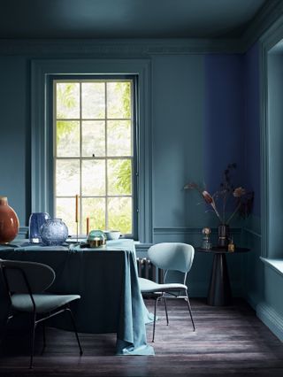 teal dining room with blue colour block wall mural painted woodwork, wooden floor