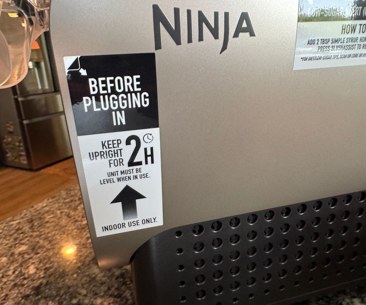 A close up view of warning label on the side of a ninja slushi twist