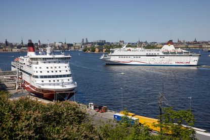 Two cruise ships lined up in port. 