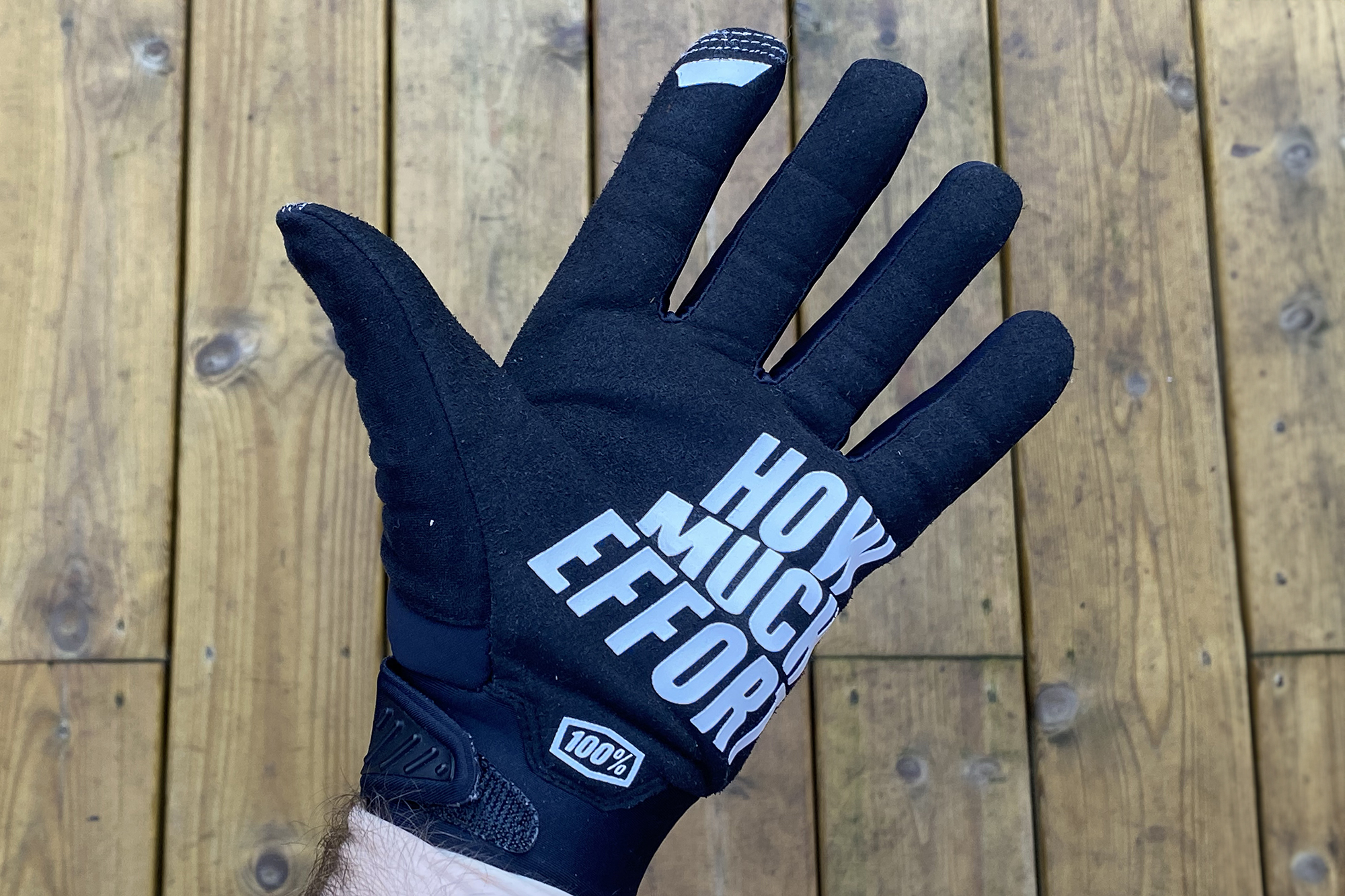 Brisker winter gloves being warn and shown palm up, to show the &#039;How Much effort&#039; and 100% logo.